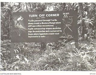 FINSCHHAFEN AREA, NEW GUINEA, 1944-03-17. ONE OF MANY BATTLE SIGNS IN THE FINSCHHAFEN AREA, THIS SIGN AT "TURN OFF CORNER" INDICATES ACTIVITIES OF THE 2/23RD AND 2/48TH INFANTRY BATTALIONS