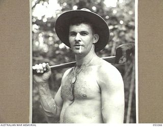 MILNE BAY, NEW GUINEA. 1943-06-30. NX89542 STAFF SERGEANT T.A. CARR OF THE 2/3RD AUSTRALIAN DOCKS OPERATING COMPANY, ROYAL AUSTRALIAN ENGINEERS, WHO HAS JUST FINISHED A SPELL AT TIMBER CUTTING IN ..