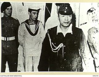 JAPANESE STAFF OFFICER ON BOARD HMS GLORY DURING THE SURRENDER OF JAPANESE FORCES AT RABAUL, 1945-09-06