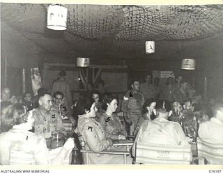 LAE, NEW GUINEA. 1944-09-25. NX201 MAJOR H.E. GLAE, CBE, CAMP COMMANDANT, HEADQUARTERS NEW GUINEA FORCE (2), AMONG GUESTS AT THE OFFICIAL OPENING OF NO. 1 SERGEANTS' MESS, HEADQUARTERS NEW GUINEA ..