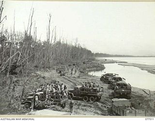 BOUGAINVILLE ISLAND. 1944-12-06. TRUCKS OF THE 133RD GENERAL TRANSPORT COMPANY WAITING TO LOAD TROOPS OF THE 15TH INFANTRY BATTALION FOR THEIR MOVE TO THE FORWARD AREAS TO TAKE OVER THE POSITIONS ..