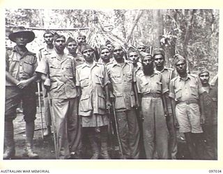 KURURAI YAMA, NEW BRITAIN. 1945-09-17. A GROUP OF LIBERATED OFFICERS AT THE INDIAN PRISONER OF WAR CAMP. THEY ARE WITH SHAK MOHMAD, THEIR HIGHEST NON REGULAR OFFICER. THESE MEN DO NOT HOLD ..