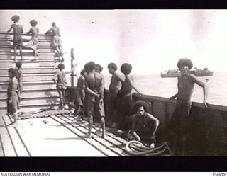 TERAPO, NEW GUINEA. 1943-09-16. BARGE OF AUSTRALIAN MOVEMENT CONTROL, WITH NATIVE LABOURERS ABOARD PROCEEDING OUT TO UNLOAD STORES FROM A TRAWLER ANCHORED OUTSIDE THE BAR OF THE LAKEKAMU RIVER