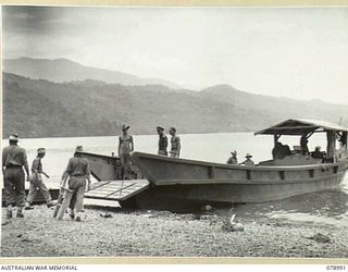 KIEP, NEW BRITAIN. 1945-02-08. VX27 MAJOR GENERAL A.H. RAMSAY, CBE, DSO, ED, GENERAL OFFICER COMMANDING, 5TH DIVISION BOARDING A JAPANESE BARGE WHICH WAS RECONDITIONED BY THE 2/137TH ARMY ..