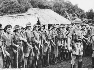 MEMBERS OF THE 39TH BATTALION, AMF, PARADE AFTER WEEKS OF FIGHTING IN DENSE JUNGLE DURING THE KOKODA CAMPAIGN. THE OFFICER IN FRONT IS LIEUTENANT JOHNSON. THE MEN STANDING BEHIND HIM, FROM THE ..