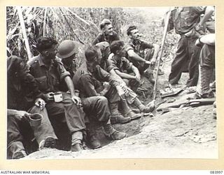 BOUGAINVILLE, SOLOMON ISLANDS. 1944-12-13. MAJOR- GENERAL W BRIDGEFORD, GENERAL OFFICER COMMANDING 3 DIVISION, (9), SPEAKS WITH MEMBERS OF A 9 INFANTRY BATTALION PATROL LED BY LIEUTENANT G F B ..
