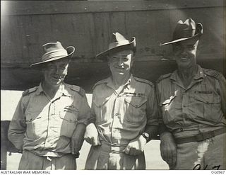AITAPE AREA, NORTH EAST NEW GUINEA. C. 1944-04-22. GROUP PORTRAIT OF TWO RAAF OFFICERS AND AN ARMY OFFICER (CENTRE) FOLLOWING THE SUCCESSFUL ALLIED LANDING