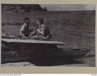 SALAMAUA, NEW GUINEA. 1945-05-19. SIGNALMAN M.P. WILLIAMS, AUSTRALIAN WOMEN'S ARMY SERVICE (1), AND SERGEANT N. ROBERTSON (2), ON A LAKATOI (NATIVE CANOE) DURING THE FIRST VISIT OF AWAS PERSONNEL ..