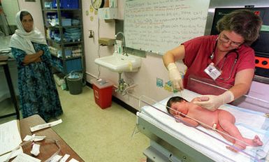 The first Kurdish evacuee to become an American due to her birth on US soil at Naval Hospital Guam is examined by US Navy Lieutenant Joyce Siler as the infant's grandmother keeps an eye on the procedure. The 8 lb. 13 oz. girl was named Helan, which means "leaving" in arabic. Helan will avoid the immigration processing required for the other Kurdish evacuees of Operation PACIFIC HAVEN currently being housed at Andersen Air Force Base, Guam. The operation, a joint humanitarian effort conducted by the US military, entails the evacuation of approximately 2,400 Kurds from northern Iraq to avoid retaliation from Iraq for working with the US government and international humanitarian agencies...