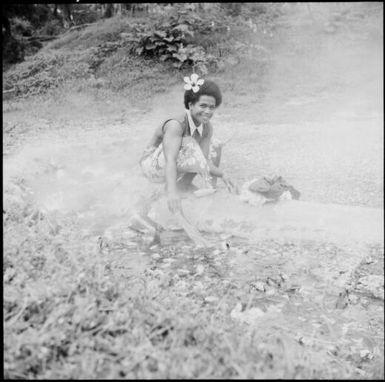 Fijian woman washing clothes in a hot springs pool, Fiji, 1966 / Michael Terry