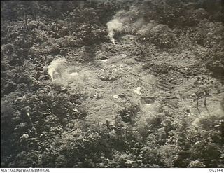 BOUGAINVILLE ISLAND, SOLOMON ISLANDS. C. 1945-01-27. AERIAL PHOTOGRAPH OF THE AREA WHERE SUPPLIES HAVE BEEN DROPPED TO AUSTRALIAN MILITARY FORCES FORWARD TROOPS FROM A DOUGLAS C47 DAKOTA TRANSPORT ..