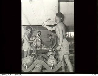 A Beaufort aircraft of No. 100 Squadron RAAF, being prepared for a raid on Gasmata by 62886 Leading Aircraftman (LAC) Albert Henry Bradbury Thompson, Ashfield, NSW; 19845 Sergeant Dugald James ..