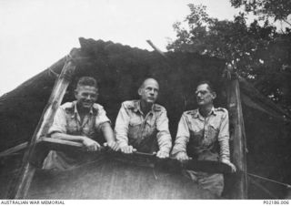 Goodenough Island, New Guinea. 1943. Three companions of the photographer Max Dupain looking out from the balcony of their hut. Left to right: Clement Seale, a soldier artist; Robert Emerson ..