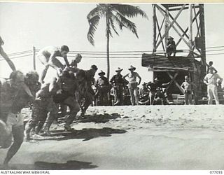 TOROKINA, BOUGAINVILLE, 1944-11-19. THE CHARIOT RACE IN PROGRESS AT THE SURF CARNIVAL ORGANISED BY HEADQUARTERS, 3RD DIVISION