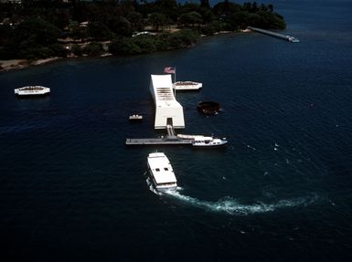 A passenger ferry approaches the USS ARIZONA MEMORIAL. Ford Island is in the background