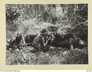 KALIMBOA, AITAPE-WEWAK SECTOR, NEW GUINEA. 1945-04-26. A JAPANESE PILLBOX WHICH HAD BEEN BLASTED BY A 2/4 ARMOURED REGIMENT MATILDA TANK. PERSONNEL OF 2/3 INFANTRY BATTALION LOOK AT THE DAMAGE. ..