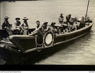 Finschhafen, New Guinea. 1943-11-20. A captured Japanese barge being used by 9th Australian Division Engineers, AIF, to transfer stores to and from the beachhead