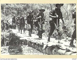 FARIA VALLEY, NEW GUINEA, 1944-02-09. MEMBERS OF THE 2/10TH INFANTRY BATTALION CROSSING THE FARIA RIVER NEAR GUY'S POST