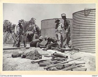 NAMANULA, RABAUL, NEW BRITAIN. 1945-10-15. ENGINEERS OF 13 FIELD COMPANY, ROYAL AUSTRALIAN ENGINEERS, PUTTING ON THE WATER SUPPLY FOR HEADQUARTERS 11 DIVISION. WATER WILL BE CHLORINATED IN THESE ..