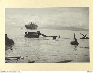 MILNE BAY, NEW GUINEA, 1944-02-12. THE TWISTED REMAINS OF TWO JAPANESE BARGES MARKING ONE OF THEIR UNSUCCESSFUL ATTACKING POINTS IN 1942-08