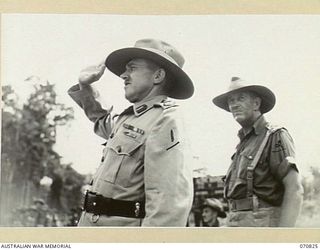 LAE, NEW GUINEA, 1944-03-08. VX20308 MAJOR-GENERAL F.H. BERRYMAN, CBE, DSO, (1), TAKES THE SALUTE DURING THE MARCH PAST OF THE 29TH INFANTRY BRIGADE. QX6152 BRIGADIER R.F. MONAGHASN (2), COMMANDER ..