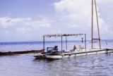 French Polynesia, person resting on catamaran off Moorea Island