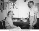 CAPT. Thomas Henry Hederman and Mr. Lorence B. Marquiss in the Captain's stateroom aboard the USS CHILTON, summer 1947