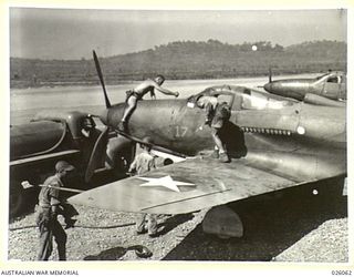 PAPUA, NEW GUINEA, 1942-07-27. AMERICAN MECHANICS DO NOT LOSE ANY TIME WHEN THE COBRA FIGHTER PLANES RETURN FROM A RAID INTERCEPTING JAPANESE ZEROS. THEY ARE QUICKLY ON THE JOB OF RE-FUELLING AND ..