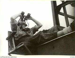 1943-07-12. AMERICAN ADVANCE INTO TROBRIAND ISLANDS. A SAILOR WATCHES FOR JAPANESE AIRCRAFT WHILST THE AMERICAN TROOPS WERE BEING TAKEN TO KIRIWINA ISLAND. NO ATTACKS BY AIR OR SEA WERE MADE ON THE ..