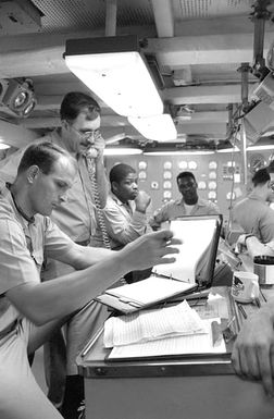 Engineering personnel aboard the amphibious assault ship USS SAIPAN (LHA-2) make preparations to shut down one of the ship's boilers for maintenance. The SAIPAN steamed at flank speed for a week to be on station off the coast of Liberia for OPERATION SHARP EDGE