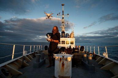 Underwater videographer Kina Scollay filming with a drone during the 2017 South West Pacific Expedition.