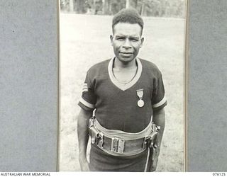 LAE, NEW GUINEA. 1944-09-12. NO. 1879 SERGEANT IWAGU, GM, ROYAL PAPUAN CONSTABULARY, A NATIVE FROM THE FINSCHHAFEN DISTRICT WHO HAS BEEN ASSOCIATED WITH THE POLICE FORCE FOR THE PAST 12 YEARS