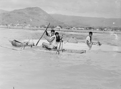 [Pacific Islanders paddling in canoes]