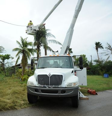 The Commonwealth Utility Corporation and Colorado Primary Source Electric crews repair power lines on the island of Saipan as part of the effort to restore long term power to the area after Typhoon Soudelor caused devastation in August.