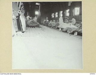 DOBODURA, NEW GUINEA. 1943-08. PATIENTS WHO HAVE PASSED THROUGH THE 10TH FIELD AMBULANCE, AUSTRALIAN ARMY MEDICAL CORPS, ABOARD A UNITED STATES ARMY AIR FORCE TRANSPORT AIRCRAFT AWAITING TAKE OFF ..