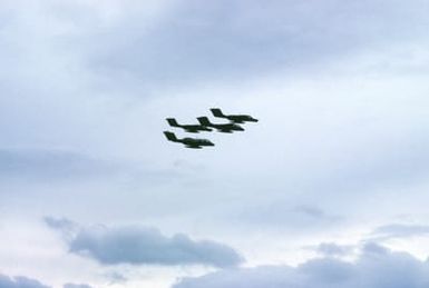 A right side view of four US Marines Corps OV-10 Bronco aircraft in flight. The aircraft are operating from the amphibious assault ship USS SAIPAN (LHA 2)