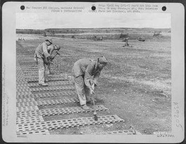 Men Of The 804Th Engineer Aviation Batallion Stake Marston Mat Down To The Ground During Extension Of Airfield To Accomodate Northrop P-61 'Black Widows'. Saipan, Marianas Islands, 25 June 1944. (U.S. Air Force Number 63693AC)