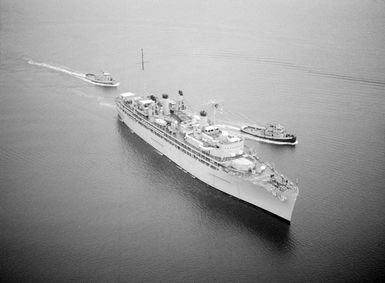 An elevated starboard bow view of the repair ship USS JASON (AR 8) entering the harbor