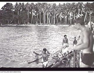 KOIL ISLAND, NEW GUINEA, 1945-10-31. A VISIT TO KOIL ISLAND WAS ARRANGED BY THE RED CROSS FOR THE PURPOSES FO MEDICAL INSPECTION OF THE NATIVE HABITANTS. THE VISITING PARTY CONSISTED OF AN ..