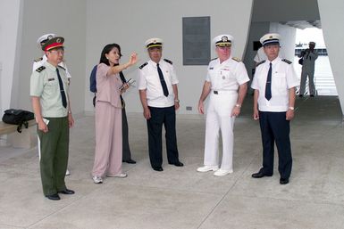 US Navy (USN) Read Admiral (RADM) Robert T. Conway Jr. (second from right), Commander, USN Region Hawaii and Chinese People's Liberation Army (Navy) Officers, are given a tour aboard the USS ARIZONA (BB 39) Memorial, at Pearl Harbor, Hawaii