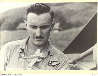 1944-03-06. NEW GUINEA. RAAF AIRMEN FIND RELAXATION IN NUMEROUS HOBBIES. THE OBSERVER TAKES PRIDE IN MODELLING MINIATURE AIRCRAFT. HE IS SEEN EXAMINING A MODEL BEAUFORT AIRCRAFT AFTER HAVING ..