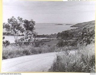 PORT MORESBY GAOL BEHIND TWO TREES ON ISLAND, AT LEFT. RAAF SURVEY FLIGHT. (NEGATIVE BY N. TRACY)