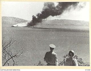 FIRST JAPANESE RAID ON PORT MORESBY. DIRECT HIT ON AN ALLIED SHIP. D. OF I. PICTURE