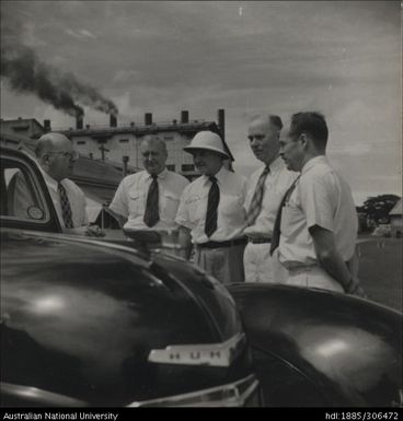 Officers having a discussion alongside vehicle